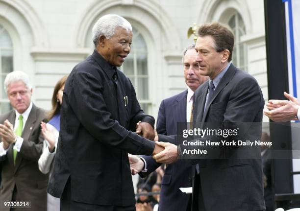 South Africa's Nelson Mandela meets Robert De Niro as Mayor Michael Bloomberg and former President Bill Clinton look on. They were there to celebrate...