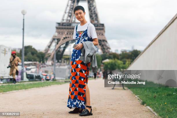 Korean model Sohyun Jung wears a sleeveless tie-dye and print dress over white Kenzo tshirt and black open heel sandals after the Hermes show during...