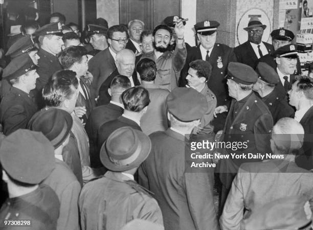 Soviet Premier Nikita Khrushchev and Cuba's President Fidel Castro are surrounded by police and crowd outside the Hotel Theresa in Harlem during...