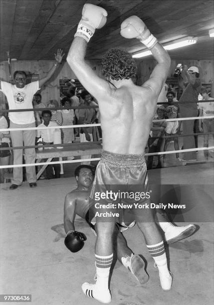 Tom Jones raises his arms in victory after "knocking out" Muhammad Ali during a boxing match at the champ's Deer Park, Penn., compound., Ali was in...