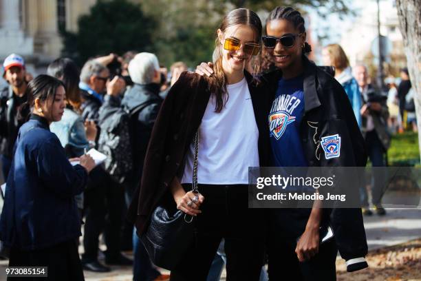 Francophone models Camille Hurel and Karly Loyce pose after the Chanel show during Paris Fashion Week Spring/Summer 2018 on October 3, 2017 in Paris,...