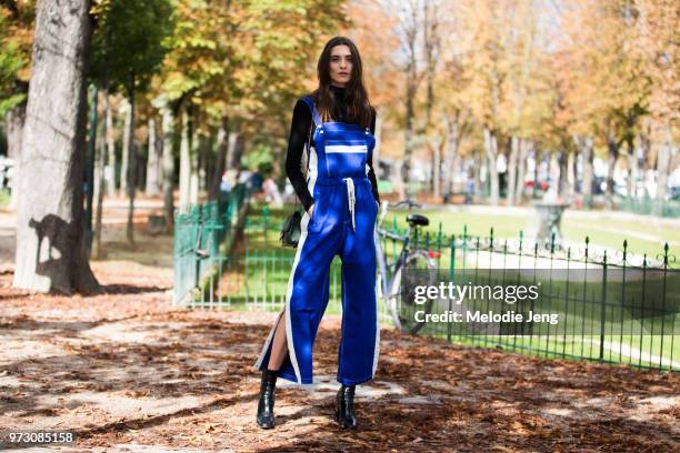 Brazilian model Carolina Thaler wears a blue and white jumpsuit and black boots during Paris Fashion Week Spring/Summer 2018 on October 3, 2017 in...