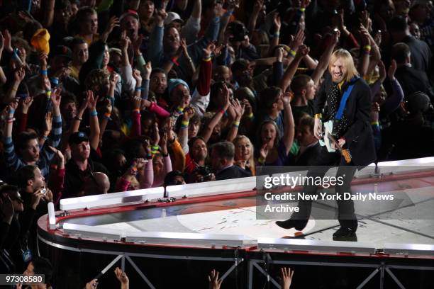 Tom Petty performs with his band Tom Petty and the Heartbreakers during the Super Bowl XLII halftime show at the University of Phoenix Stadium.