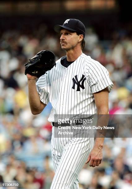 New York Yankees' pitcher Randy Johnson reacts after Tampa Bay Devil Rays' Damon Hollins goes home in the second inning of a game at Yankee Stadium....