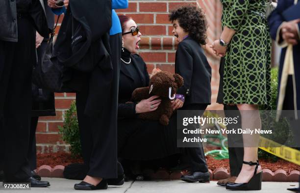 Tomi Rae Brown tries to cheer up her son, James Brown 2d, as they wait to attend a private service for soul legend James Brown at the Carpentersville...
