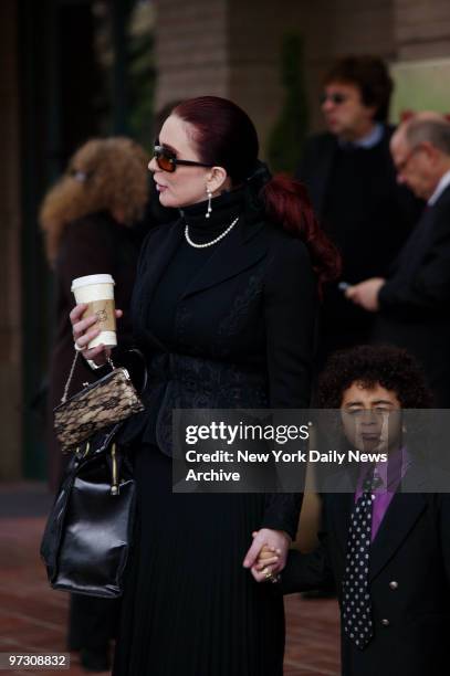 Tomi Rae Hynie and her son, James Brown 2d, leave the Marriott Hotel in Augusta, Ga., on their way to the Carpentersville Baptist Church in North...