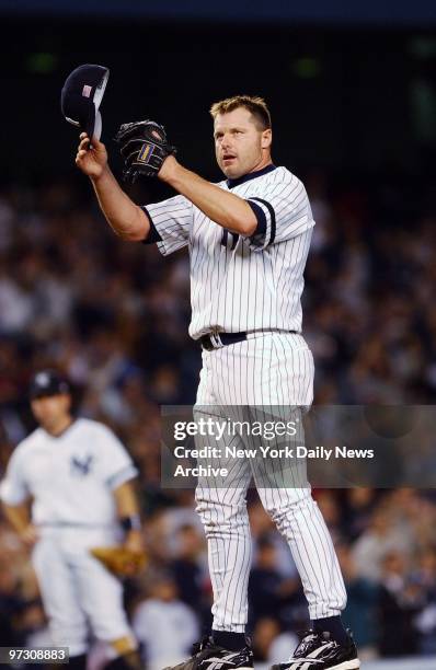 New York Yankees' pitcher Roger Clemens doffs his hat to the cheering fans after moving into third place on the all-time strikeout list in the fourth...