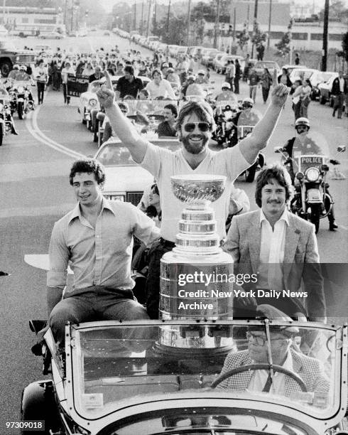 New York Islanders' Denis Potvin with Duane Sutter and Steve Tambellini in parade car with the Stanley Cup outisde Nassau Coliseum.