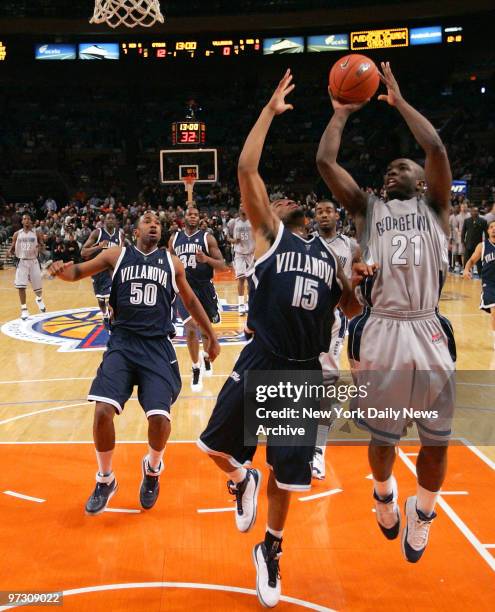 Georgetown Hoyas' Jessie Sapp takes a shot at the basket over Villanova Wildcats' Reggie Redding during the first half of a Big East Tournament...