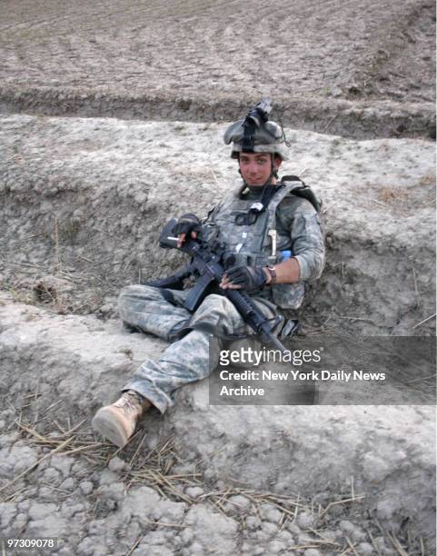 Spec. Corey Terry Baltimore, the medic for the 10th Mountain, 3rd Brigade, 3rd Squadron, 71st Cavalry Regiment?s route clearance team takes a break...