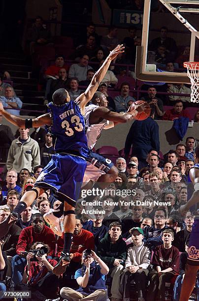 Georgetown's Demetrius Hunter goes up for two points as Seton Hall's Eddie Griffin tries in vain for a block in the Big East tournament quarterfinals...