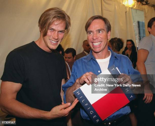 Tommy Hilfiger gets together with model Jason Lewis backstage at the Spring '97 fashion show at the Pavilion.