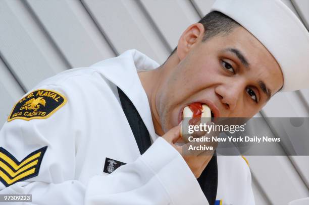 Danny Jimenez, a Naval Sea Cadet from Staten Island, takes bite of a hot dog during a Memorial Day parade in Greenpoint Brooklyn, sponsored by the...