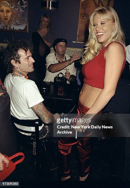 Tommy Lee looking over Penthouse Pet Paige Summers during benefit for the Leslie Glass Cancer Fund at the China Club.,