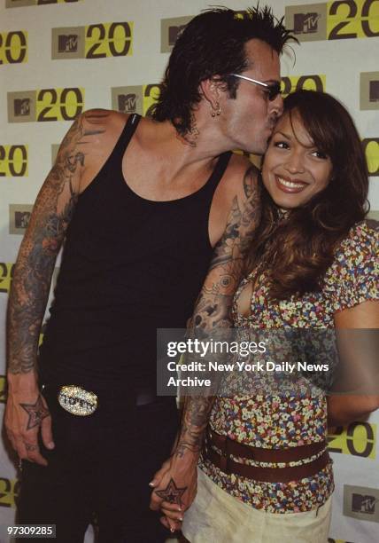 Tommy Lee of Motley Crue plants a smooch on girlfriend Mayte Garcia on their arrival at Hammerstein Ballroom to celebrate the 20th anniversary of MTV.