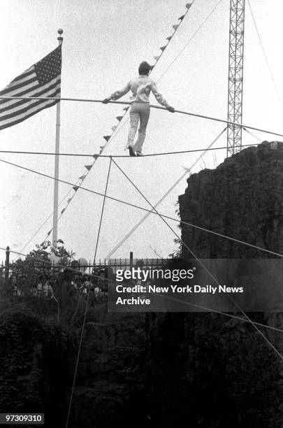 Spectators gape as high-wire artist Philippe Petit makes his way across the gorge at Great Falls in Paterson, N.J. Nearly 15,000 people watched as...