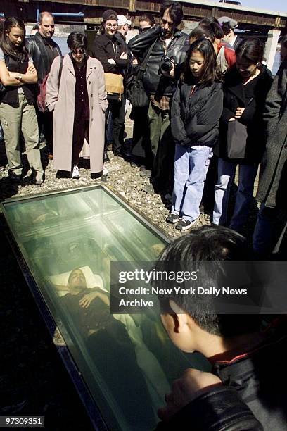 Spectators look on as magician David Blaine is buried alive at Riverside Drive and W. 68th St. Blaine plans to remain in his plexiglass casket, with...