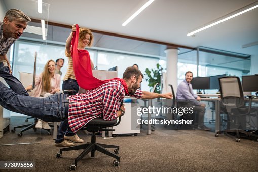 Group of playful colleagues having fun on a break at casual office. Group of playful colleagues having fun on a break at casual office.