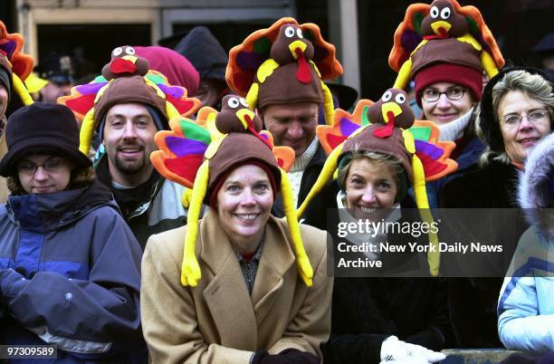 Spectators sport turkey toppers as they watch floats, giant balloons, clowns and marching bands pass by in the 76th annual Macy's Thanksgiving Day...