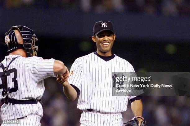 New York Yankees' reliever Mariano Rivera gets a handshake from catcher Todd Greene after completing the final six outs to sew up the Yanks' 9-7 win...