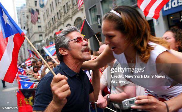 Geraldo Rivera licks his lips as he prepares to give a parade watcher a kiss during the 50th annual Puerto Rican Day Parade along Fifth Ave.