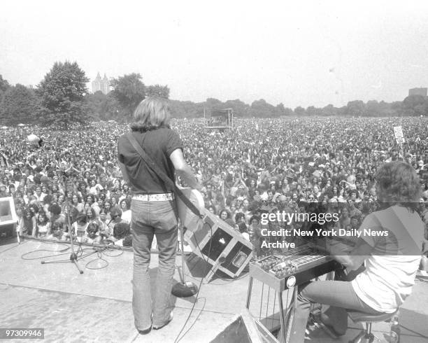 David Nelson wields lead guitar as New Riders of the Purple Sage gallop all over stage in Central park. Free four-hour concert on the Great Lawn,...