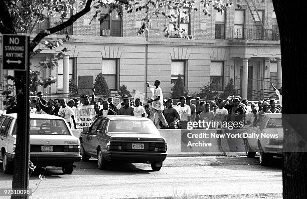 Demonstrators movie along Eastern Parkway during the riots in Crown Heights. Rioting erupted after two black 7-year-olds, Gavin and Angela Cato, were...