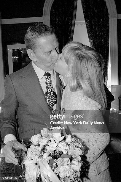Tony Randall kisses his bride Heather Harlan after they exchanged vows at City Hall.,