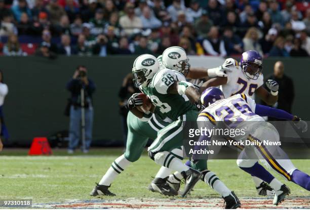 New York Jets' Curtis Martin carries the ball past Minnesota Vikings' defenders in action at Giants Stadium. Martin rushed for 70 yards on 18...