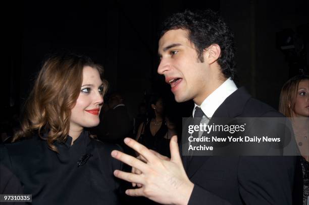 Drew Barrymore talks with boyfriend Fabrizio Moretti, a drummer with the band The Strokes, during a pre-Grammy party in the Grand Ballroom of the...