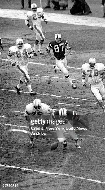 New York Jets' fullback Matt Snell fumbles a Joe Namath handoff while being chased by Dolphins' Manuel Fernandez. Ball was recovered by Namath.