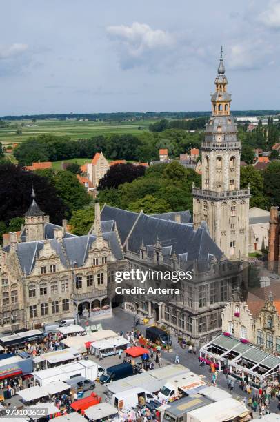The belfry and stallholders at the Main market square / Grote Markt at the city Veurne / Furnes, West Flanders, Belgium.