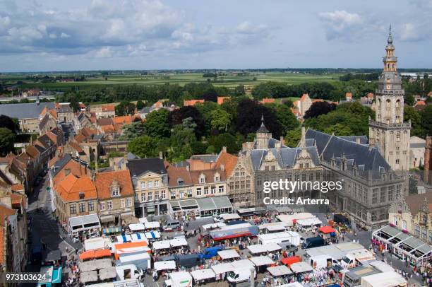 The belfry and stallholders at the Main market square / Grote Markt at the city Veurne / Furnes, West Flanders, Belgium.