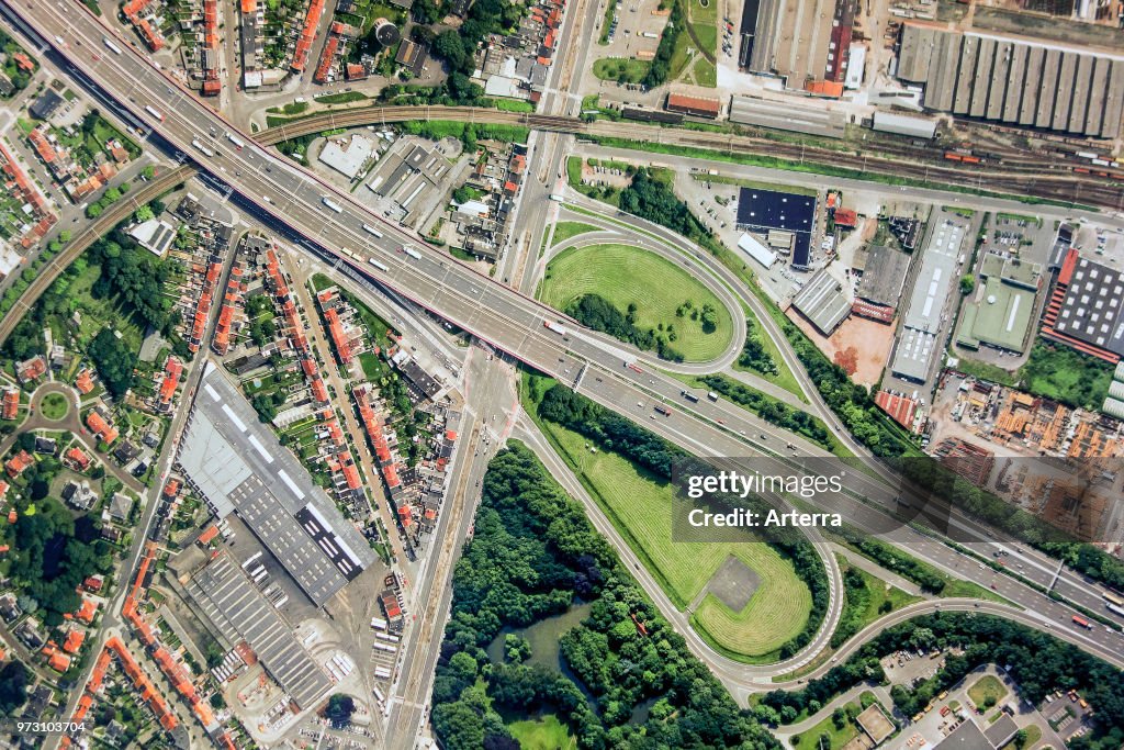 Aerial view over ribbon building and highway interchange.