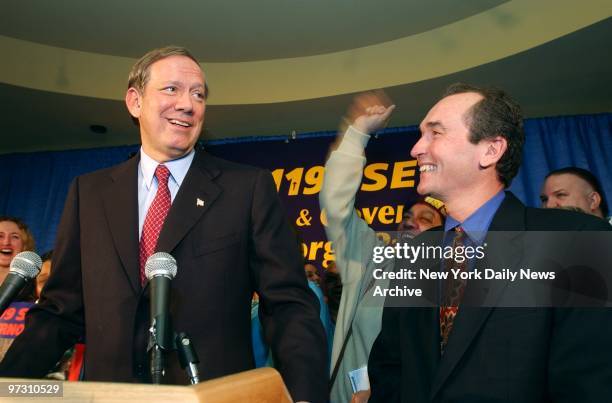 Gov. George Pataki draws a smile from Dennis Rivera , head of health-care workers union 1199, as he answers a reporter's question in Spanish at...