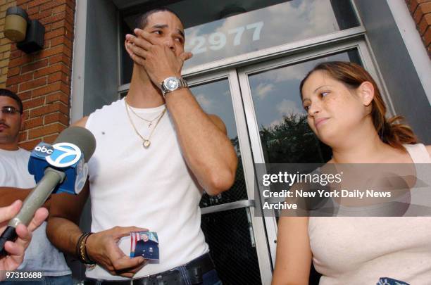 Julio Concepcion, brother of off-duty cop Eric Concepcion, holds back tears as he and his brother's wife, Melissa Vincens, speak to media regarding...