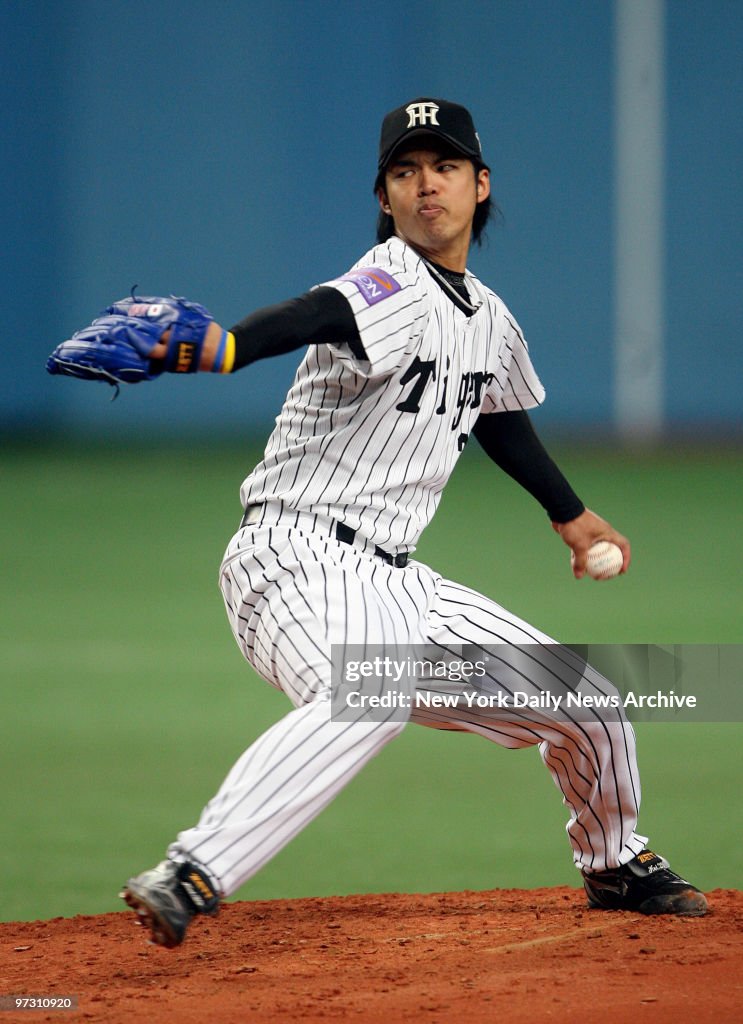 Hanshin Tigers' starter Kei Igawa delivers a pitch during th