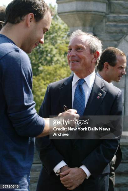 Dave Matthews signs his autograph for Mayor Michael Bloomberg at Belvedere Castle in Central Park. Matthews announced that his band will perform at a...