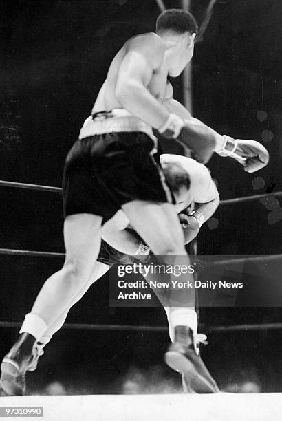 Tony Galento, fighting out of a crouch that puzzled Joe Louis early in fight, ducks under a vicious Louis left. Louis connected in the fourth,...