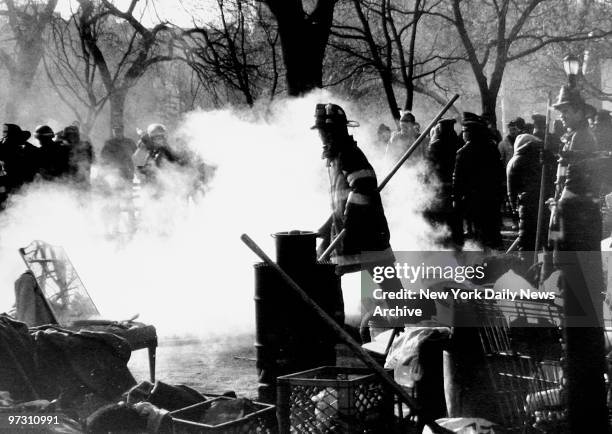 Squatters burn their prefab homes in Tompkins Square Park while firemen extinguish the fires.