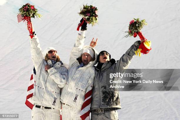 Gretchen Bleiler and Hannah Teter, both of the U.S., and Kjersti Buass of Norway celebrate their victories in the Women's Halfpipe Snowboard...