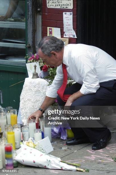 Mayor Michael Bloomberg places a candle at a makeshift memorial outside the office of Councilman James Davis on DeKalb Ave. In Brooklyn. Davis was...