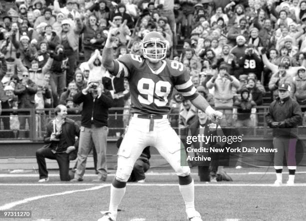 New York Jets' Mark Gastineau celebrates after sacking Green Bay Packer Lynn Dickey.