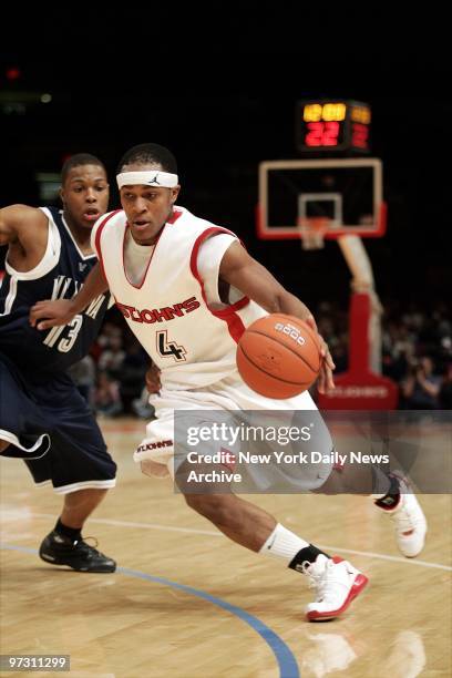 St. John's Eugene Lawrence drives past the Villanova Wildcats' Kyle Lowry during second half of game at Madison Square Garden. The Wildcats went on...