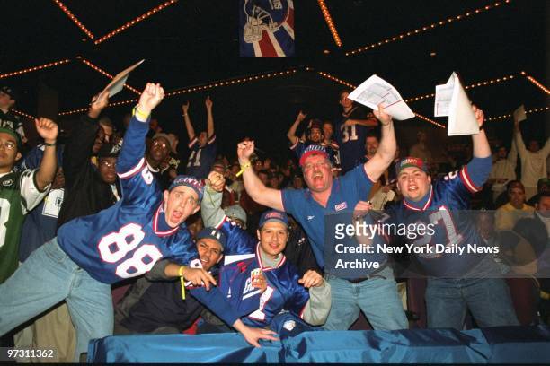 Giants and Jets fans make their wishes known at the NFL draft in the theater at Madison Square Garden.