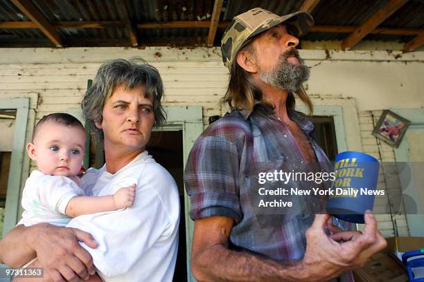 Judy Smith, holding Claire Marie Young, stands alongside Carl Young on the porch of their Jena, La. Home, as they watch a demonstration of more than...