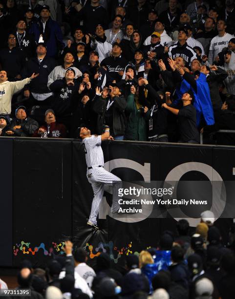New York Yankees right fielder Nick Swisher goes to the right field wall but can't get a hold of a homerun by Philadelphia Phillies second baseman...