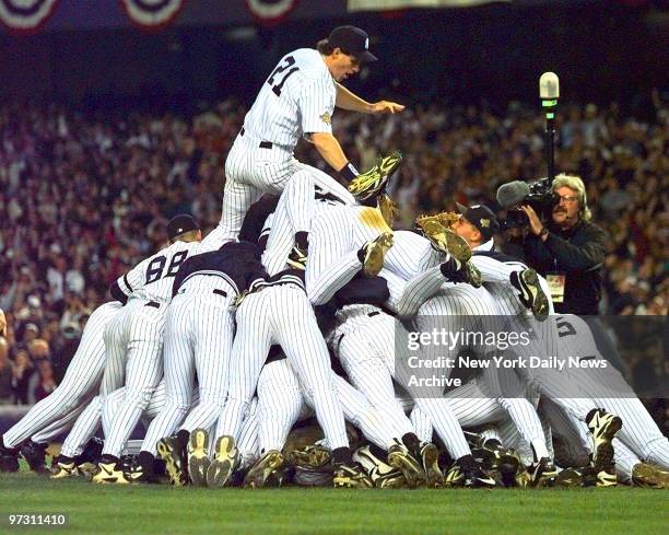 New York Yankees' right fielder Paul O'Neill tops the Yankees pileup at the end of game six of the 1996 World Series at Yankee Stadium. The 3-2 win...