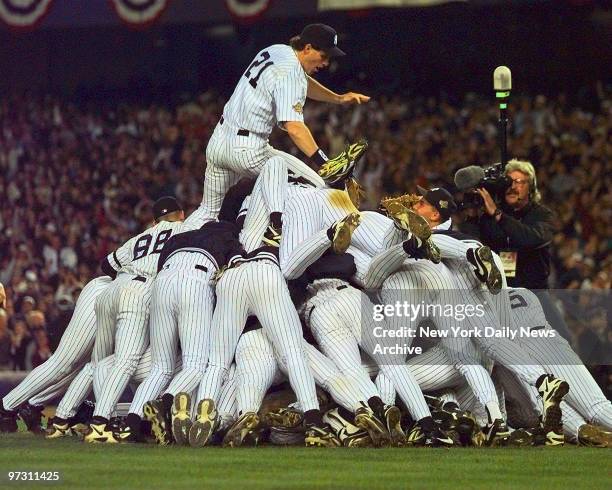 New York Yankees' right fielder Paul O'Neill tops the Yankees pileup at the end of game six of the 1996 World Series at Yankee Stadium. The 3-2 win...