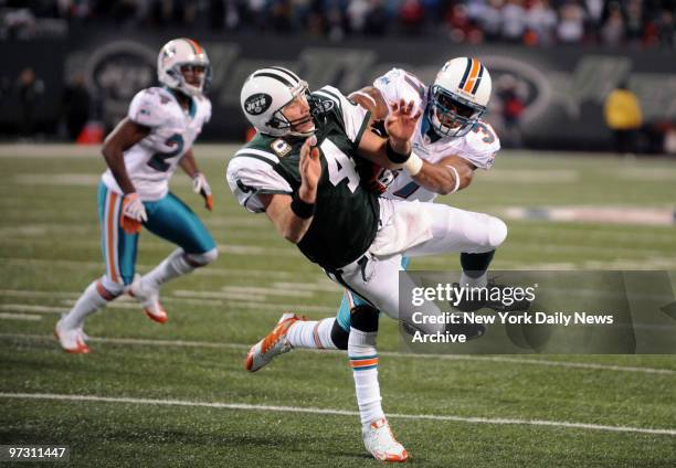 New York Jets quarterback Brett Favre is hit hard on his last play of the game., New York Jets against the Miami Dolphins.